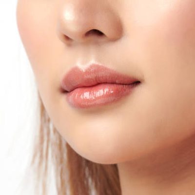 Close up photo with beautiful female face, Sexy plump full lips. Close-up face detail. Perfect natural lip makeup.